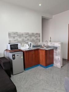 a kitchen with a sink and a microwave at Mirage in Tarrafal +26 photos