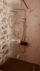 a shower with a glass door in a bathroom at Althea Village in Areopoli +68 photos