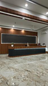 a lobby with a reception desk in a building at Aadyanta in Kadūr