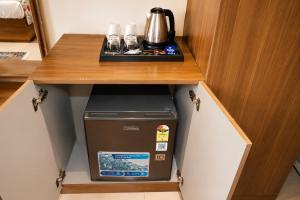 a small refrigerator in a cabinet in a room at Jalsa Heritage- A Boutique Hotel in Jaipur