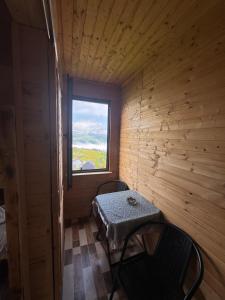 a small room with a table and a window at Gomismta Sky House in Gomi
