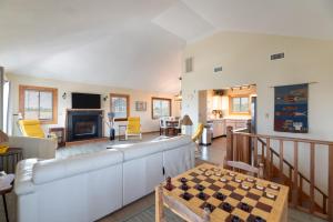 a living room with a couch and a chess board at Knottaway - Duck, Sound Sea Village, Ocean View, 125 Yds to Beach, Pets OK, Flex Stays in Duck