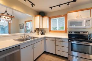 a kitchen with white cabinets and a sink at Knottaway - Duck, Sound Sea Village, Ocean View, 125 Yds to Beach, Pets OK, Flex Stays in Duck