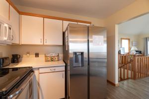 a kitchen with a stainless steel refrigerator at Knottaway - Duck, Sound Sea Village, Ocean View, 125 Yds to Beach, Pets OK, Flex Stays in Duck