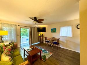 a living room with a couch and a table at Ideal Coconut Coast Condo in Kapaa