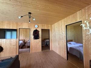 a room with a bed and a clock on the wall at Chalet Gveleti in Barisakho