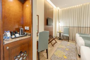 a hotel room with a bed and a bathroom at Maysan Rotana El Mysk Fully Renovated in Medina