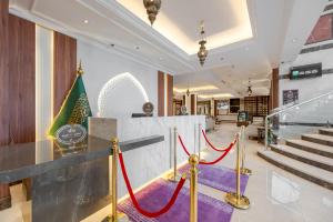 a lobby with red ropes in a building at Maysan Rotana El Mysk Fully Renovated in Medina