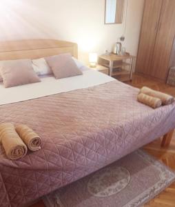 a bedroom with a large bed with towels on it at Guest House Mila in Plitvička Jezera