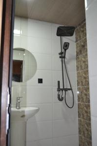 a bathroom with a shower and a sink at Chalet Gveleti in Barisakho