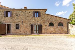 an external view of a stone house with a driveway at Casale Bianca Luce in Santa Luce