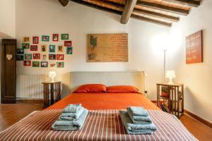 a bedroom with a bed with two towels on it at Casale Bianca Luce in Santa Luce