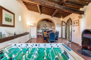an estate with a pool table and a dining room at Casale Bianca Luce in Santa Luce