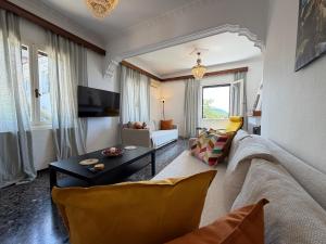 a living room with a couch and a table at Demie and George Ηouse in Loutraki