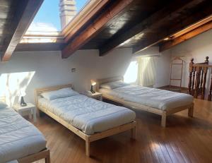 a bedroom with two beds and a skylight at Viale Monza Chic Stay - Affitti Brevi Italia in Milan