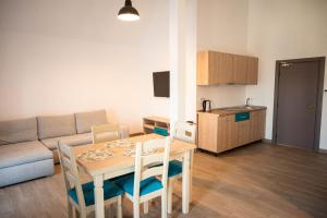 a small living room with a table and a couch at Kazeboo Bed & Breakfast in Mamaia Sat/Năvodari
