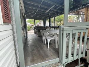 a porch with a table and chairs on it at Mobile Home Agde Les Sables D'or in Le Grau-dʼAgde