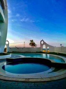 a large swimming pool in the middle of a building at Kmayra Diamond in Harqalah