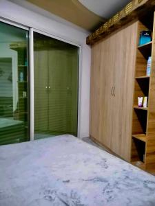 a bedroom with a bed and a sliding glass door at Kmayra Diamond in Harqalah +13 photos