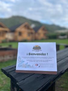 a sign sitting on top of a table in front of a house at San Marcos Mountain Lodge in Chontabamba