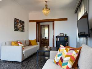 a living room with a couch and a table at Demie and George Ηouse in Loutraki