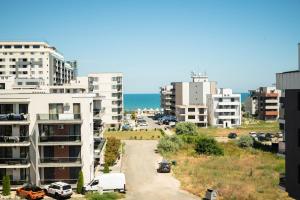 a street in a city with buildings and the ocean at Kazeboo Bed & Breakfast in Mamaia Sat/Năvodari