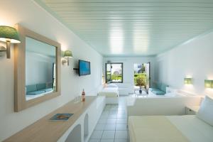 a living room with white furniture and a tub at Canvas by Mitsis Cretan Village in Hersonissos +44 photos