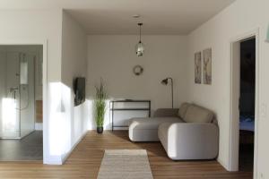 a living room with a couch and a table at Glöckle Mühle, Ferienwohnungen und Camping mit Sauna in Herbolzheim