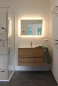 a bathroom with a sink and a mirror at Glöckle Mühle, Ferienwohnungen und Camping mit Sauna in Herbolzheim