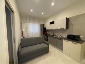 a kitchen with a couch in a small room at Casa Varone del Vesuvio in Torre Annunziata +4 photos