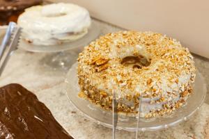two donuts sitting on plates on a counter at Hotel Somensi in Bento Gonçalves