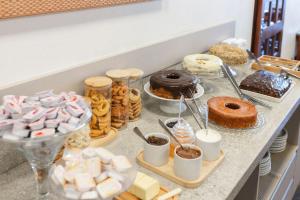 a buffet with different types of pastries and desserts at Hotel Somensi in Bento Gonçalves +30 photos