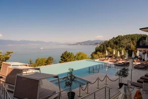 a large swimming pool with a view of a lake at Inex Olgica Hotel & SPA in Ohrid +82 photos