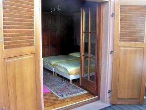 a small room with a bed and a glass door at Le Sonnenglanz in Beblenheim