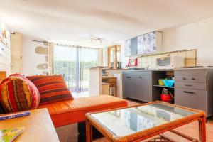 a living room with a couch and a table at Appartement de charme en Ardèche in Aubenas +15 photos