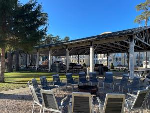 a group of chairs and a fire pit in a park at Marena Wellness & Spa in Międzywodzie