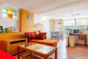 a living room with a couch and a table at Appartement de charme en Ardèche in Aubenas