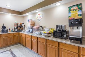 a kitchen with a counter with a microwave and a coffee maker at Super 8 by Wyndham Rock Falls Sterling Area in Rock Falls