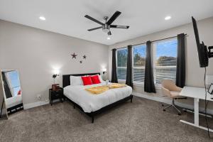 a bedroom with a bed and a ceiling fan at Lux, Fenced Backyard 4 Pets, Firepit, Exec Desk in Dallas