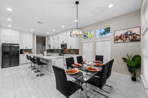 a kitchen and dining room with a table and chairs at Lux, Fenced Backyard 4 Pets, Firepit, Exec Desk in Dallas