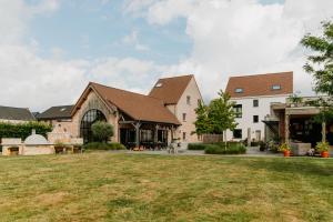 a group of buildings with a grass yard at Casa Cava B&B in Dendermonde