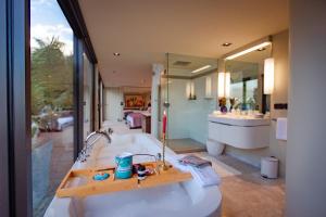 a bathroom with a tub and a large mirror at Lodge by the beach - Luxury, Beach access, Ocean views, Private chef in Kaiteriteri +186 photos