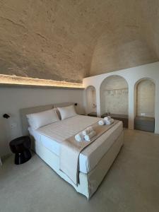 a bedroom with a large bed with white pillows at Casa Nacci Accoglienza di Lusso in Brindisi