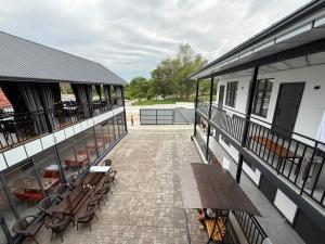 a patio with benches and tables on a building at Edelweiss 2 in Bosteri