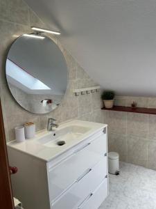 a bathroom with a white sink and a mirror at Finca la Tierruca de Cudon in Cudón +28 photos