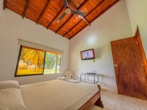 a bedroom with a large bed and a window at Finca Campestre Doradal in Doradal