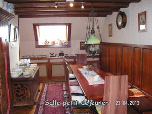 a kitchen with a table and a dining room at Le Sonnenglanz in Beblenheim +12 photos