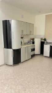 a large kitchen with white and black appliances at شقه فندقه in Hail
