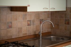 a kitchen with a sink and a faucet at Residence Da Carmelo in Palinuro