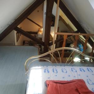 a hospital bed in a room with an attic at Hébergement VIGNES ET RIVIERES in Écuelles